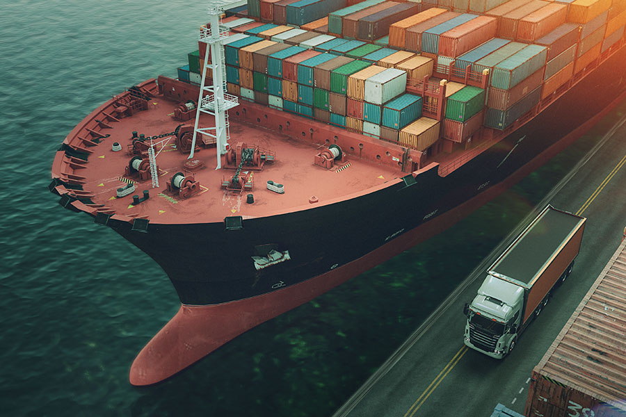 Specialized Business Insurance - Large Cargo Ship At Port Next To Shipping Containers And Truck